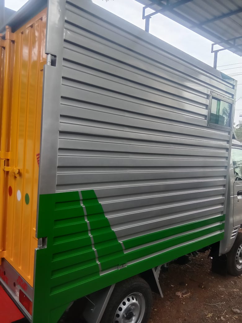 Container truck with silver and green panels